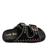 Mules in camoscio e pelle con borchie 