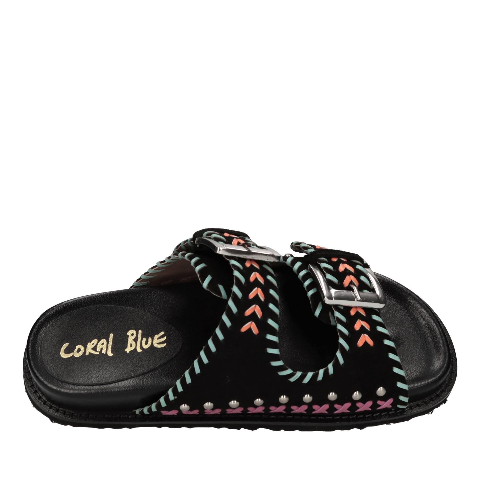 Mules in camoscio e pelle con borchie 